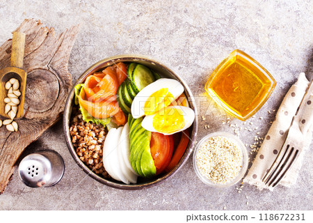 Healthy vegan nutritious bowl with buckwheat. Salad of avocado, salmon, buckwheat, egg and tomato 118672231