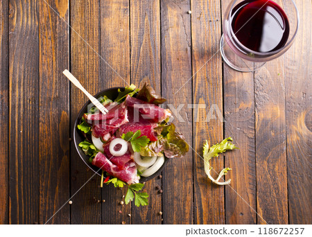 Sliced Pastrami roasted beef meat with herbs and vegetables 118672257