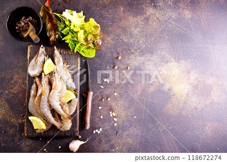 Raw tiger white shrimp prawn on board with herbs. Dark background. Top view. 118672274