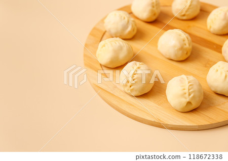 Close-up of savory Central Asian manti with meat on rustic wooden surface, frozen dumplings, place for text. Close-up of savory Central Asian manti with meat on rustic wooden surface, frozen dumplings, place for text. 118672338