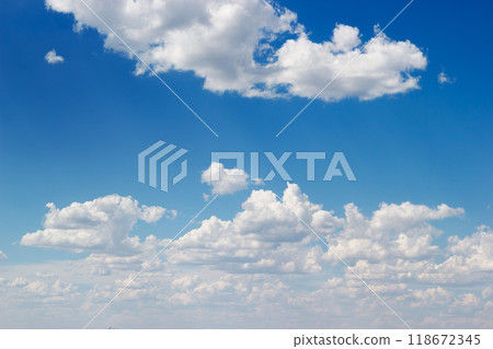 An azure sky filled with fluffy white cumulus clouds stretches. An azure sky filled with fluffy white cumulus clouds stretches. 118672345