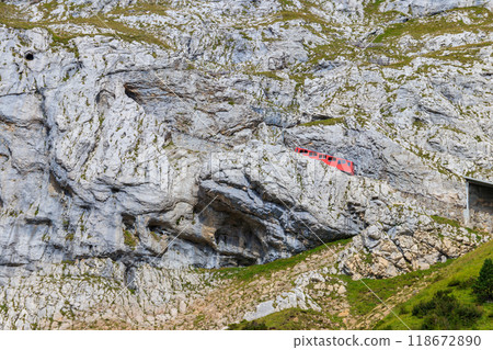Cogwheel train climbing to the top of Mount Pilatus in Canton Lucerne, Switzerland. World's steepest cogwheel railway Cogwheel train climbing to the top of Mount Pilatus in Canton Lucerne, Switzerland. World's steepest cogwheel railway 118672890