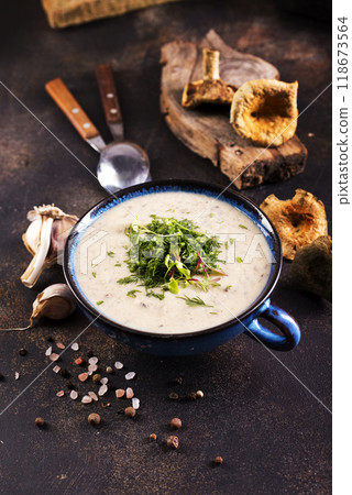 cream soup with dry mushrooms in bowl 118673564
