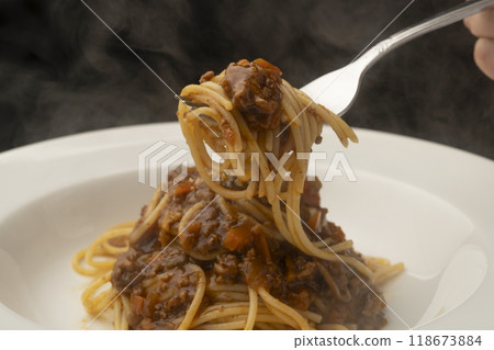 Spaghetti with meat sauce: Roll the pasta around a fork and lift it up 118673884