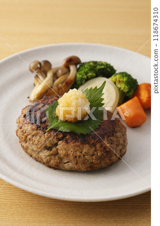 Japanese-style hamburger steak topped with grated daikon radish Japanese-style hamburger steak topped with grated daikon radish 118674310