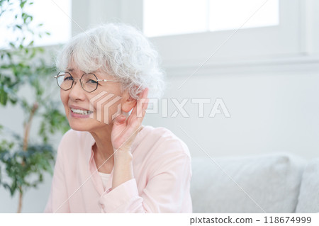 Elderly woman who is hard of hearing 118674999