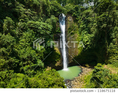 Alalum Falls with green plunge pool surrounded by lush vegetation. Mindanao, Philippines. 118675118