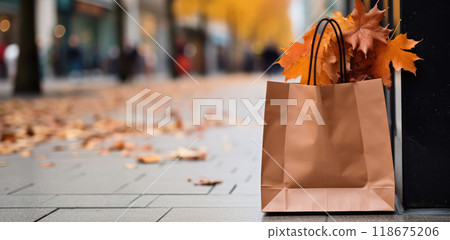 Ai generated Paper shopping bag with fallen maple leaves in autumn park with copy space Ai generated Paper shopping bag with fallen maple leaves in autumn park with copy space 118675206