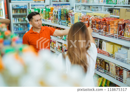 man and woman scramble for items to be picked up man and woman scramble for items to be picked up 118675317
