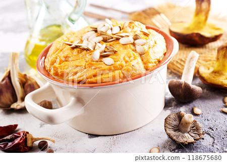 Vegetarian autumn pumpkin cream soup with mushrooms and seeds Vegetarian autumn pumpkin cream soup with mushrooms and seeds 118675680