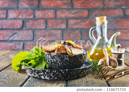 Bowl with baked potatoes on wooden background Bowl with baked potatoes on wooden background 118675720