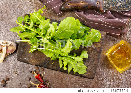 Fresh arugula leaves, rucola on wooden board 118675724