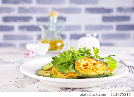 Heap of fried green zucchini with garlic Heap of fried green zucchini with garlic 118675815
