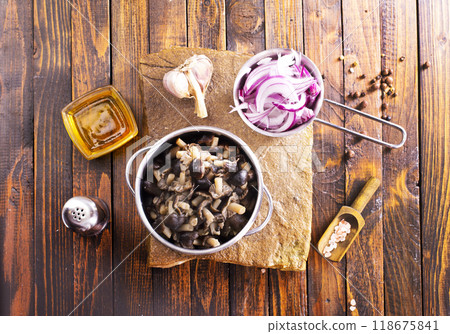 pickled mushrooms in metal bowl on the table, next to spices. pickle mushrooms pickled mushrooms in metal bowl on the table, next to spices. pickle mushrooms 118675841