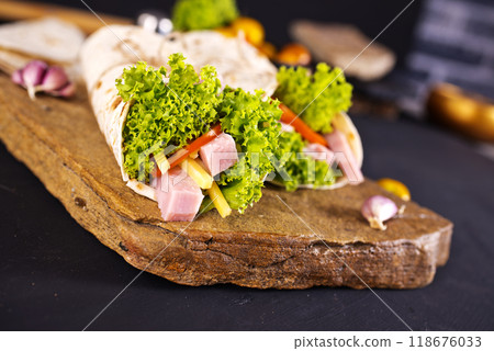 Fresh tortilla wraps with ham cheese and vegetables Fresh tortilla wraps with ham cheese and vegetables 118676033