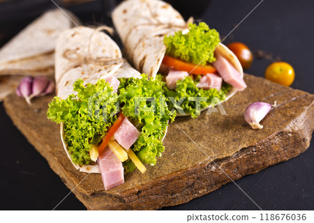 Fresh tortilla wraps with ham cheese and vegetables Fresh tortilla wraps with ham cheese and vegetables 118676036