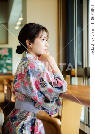 A woman in a yukata on a chair A woman in a yukata on a chair 118676091