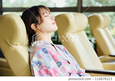 Woman relaxing at the inn Woman relaxing at the inn 118676223