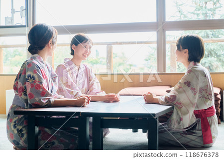 Women conversing at an inn Women conversing at an inn 118676378