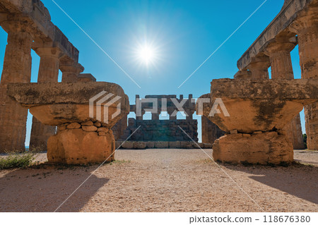 Ancient temple ruins and shining sun 118676380
