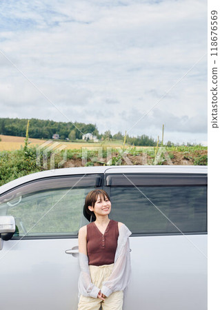 A woman driving through the great outdoors 118676569