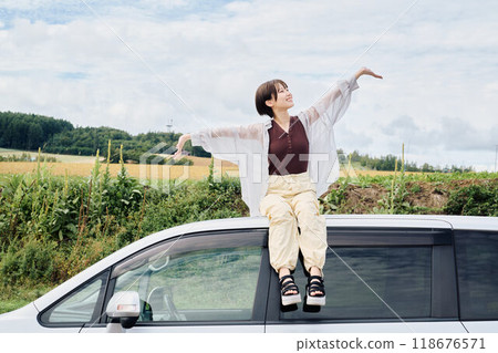 A woman driving through the great outdoors 118676571