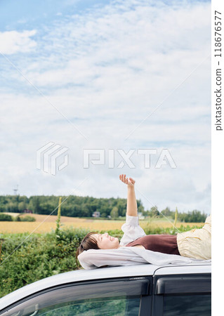 A woman driving through the great outdoors A woman driving through the great outdoors 118676577
