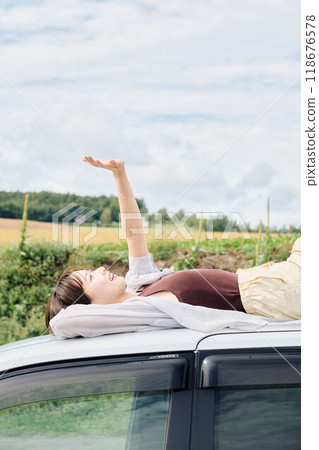 A woman driving through the great outdoors A woman driving through the great outdoors 118676578