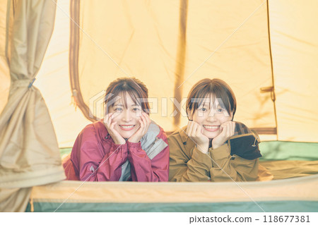 Women camping in the wilderness Women camping in the wilderness 118677381