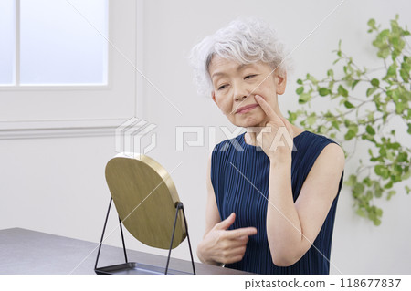 Elderly woman suffering from nasolabial folds 118677837