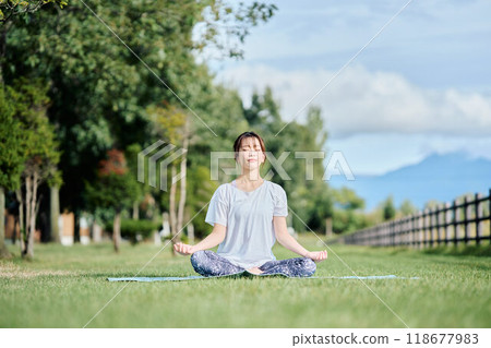 woman doing yoga in nature woman doing yoga in nature 118677983