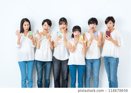 Multi-generational women looking at smartphones Multi-generational women looking at smartphones 118678656