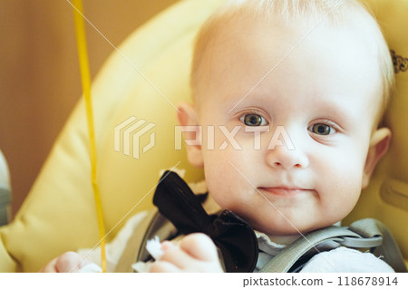 Pretty Baby Boy Sitting In Yellow Seat 118678914