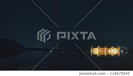 Jaipur, Rajasthan, India. Panoramic View On Jal Mahal Or Water Palace In Night Illumination. Palace Inmiddle Of Man Sagar Lake. Reflections In Dark Water. Originally Constructed Around 1699. Jal Mahal 118678945