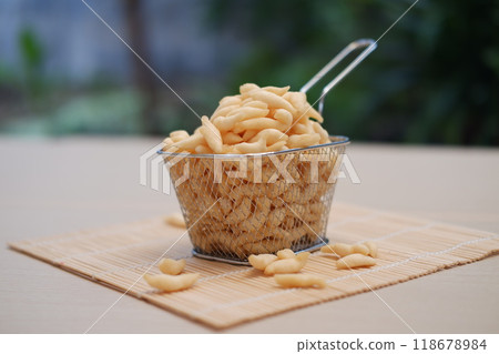 telur gabus sticks in a metal basket on wooden table telur gabus sticks in a metal basket on wooden table 118678984