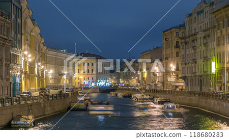 Moyka river timelapse in Saint Petersburg, Russia at night with a motion blurred touristic boat, illuminated old buildings. Moyka river timelapse in Saint Petersburg, Russia at night with a motion blurred touristic boat, illuminated old buildings. 118680283