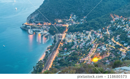Day to night timelapse view of the Mediterranean coastline of the town of Eze village on the French Riviera Day to night timelapse view of the Mediterranean coastline of the town of Eze village on the French Riviera 118680373