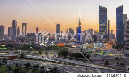Skyline with Skyscrapers day to night timelapse in Kuwait City downtown illuminated at dusk. Kuwait City, Middle East 118680648