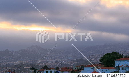 Sunset over houses from hill in Funchal, Madeira, Portugal timelapse 118680712