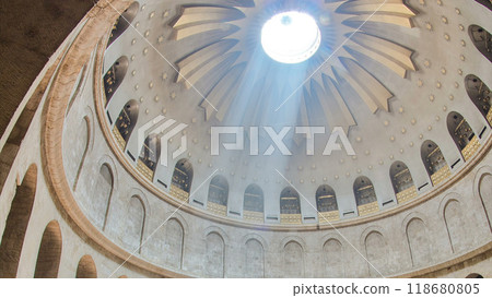 Crowd of people and ray of sun from dome in the Church of the Holy Sepulcher timelapse. 118680805