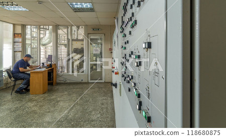 Factory Control Panel timelapse hyperlapse. Engineer standing in front of the control panel in the control room and pushing buttons and switches 118680875