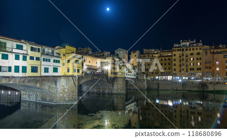 Famous Ponte Vecchio bridge timelapse hyperlapse over the Arno river in Florence, Italy, lit up at night 118680896