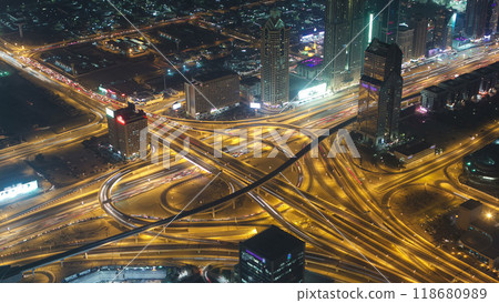 Dubai downtown intersection traffic night with city lights from above timelapse 118680989