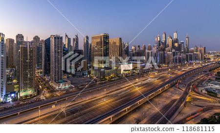 Dubai marina with traffic on sheikh zayed road panorama day to night timelapse lights turn on. Dubai marina with traffic on sheikh zayed road panorama day to night timelapse lights turn on. 118681115