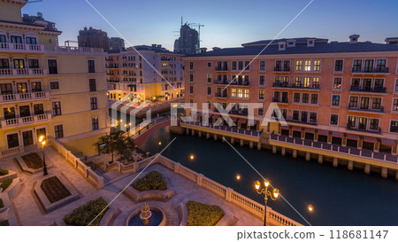 Canal aerial top view in Venice-like Qanat Quartier of the Pearl precinct of Doha day to night timelapse, Qatar. 118681147