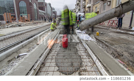 Pouring ready-mixed concrete after placing steel reinforcement to make the road by concrete mixer timelapse hyperlapse. 118681236
