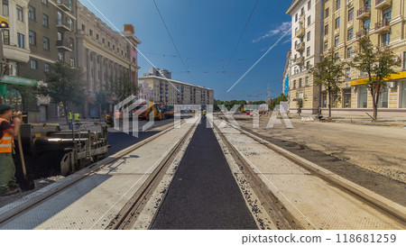 Workers operating asphalt paver machines during road construction and repairing works timelapse 118681259