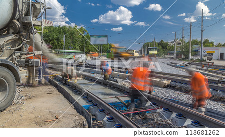 Pouring ready-mixed concrete after placing steel reinforcement to make the road by concrete mixer timelapse. 118681262
