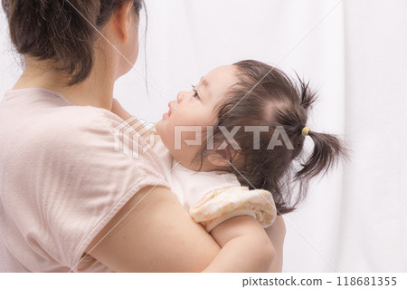 [Baby with twin tails being held by grandmother] 118681355