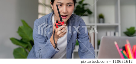 Female Engineer Communicating via Radio for Effective Project Coordination in Office 118681612
